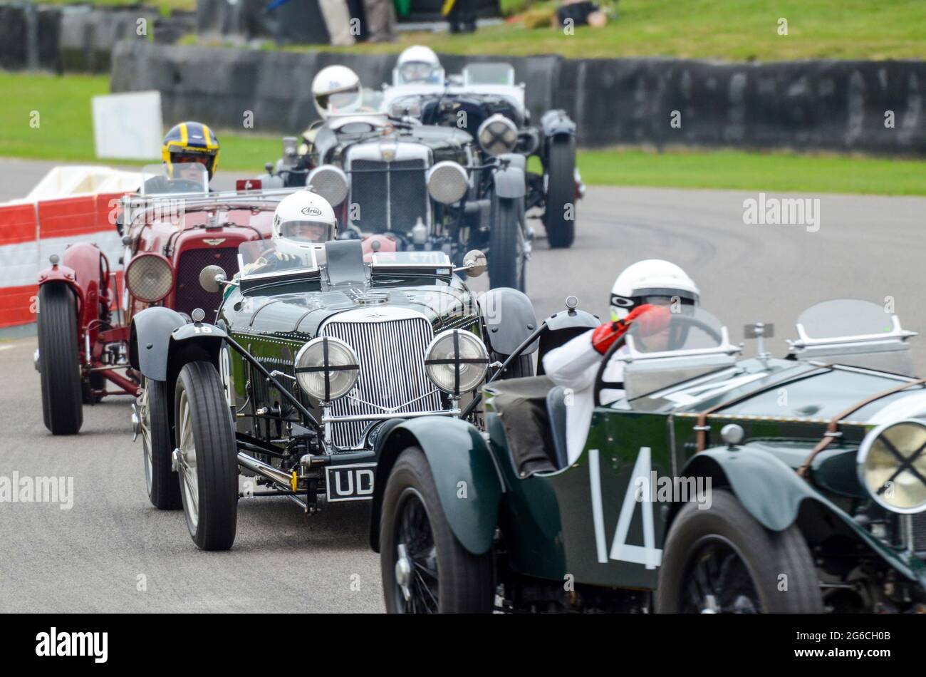 Classic, vintage racing cars competing in the Brooklands Trophy at the Goodwood Revival historic event, UK. Invicta, Squire, Aston Martin historic car Stock Photo