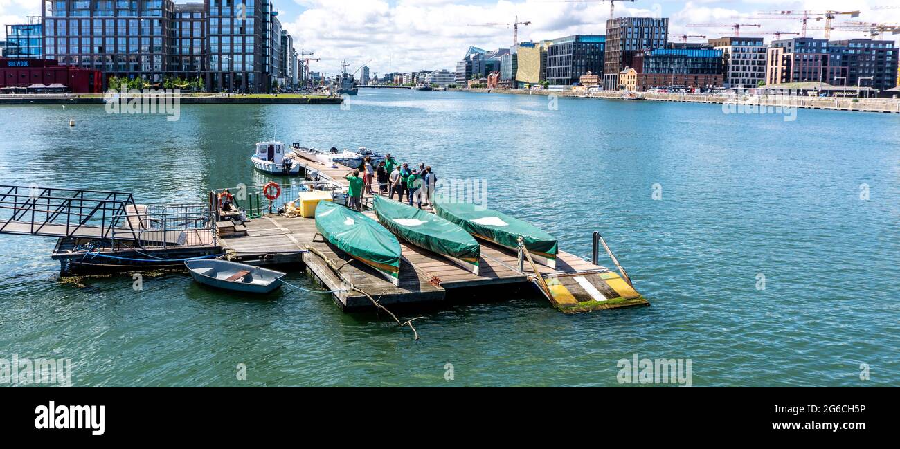 Members of St Patricks Rowing Club in Dublin, Ireland gathered at their base near Ringsend on the River Liffey. Stock Photo