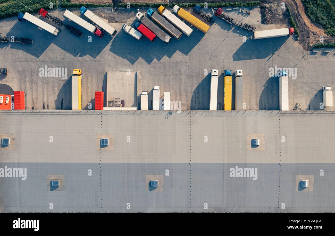 Trucks with trailers are loaded and unloaded in the cargo terminal in ...