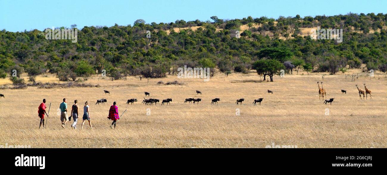 Kenya: savanna landscape with wildlife and local hunters Stock Photo