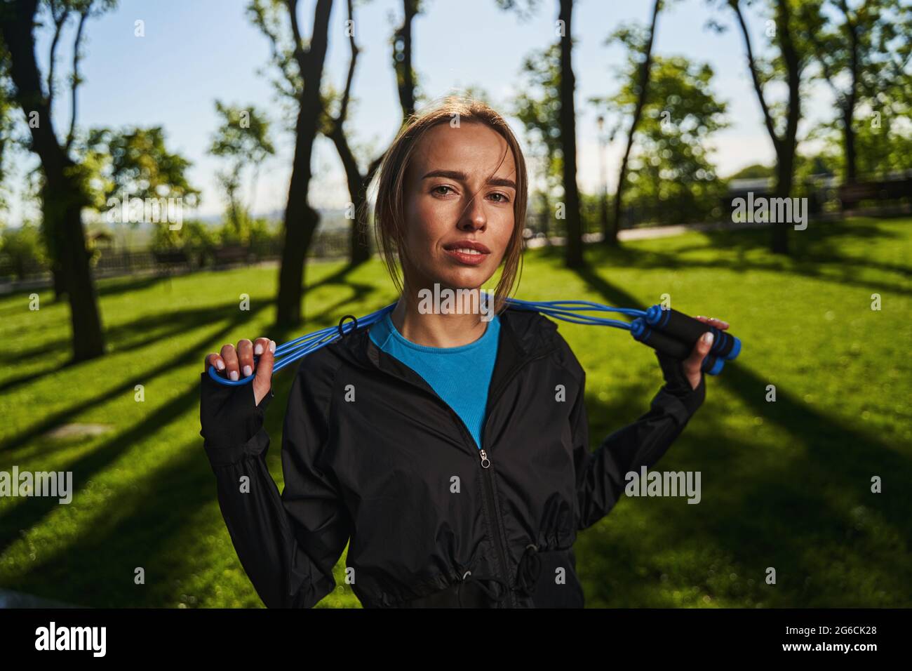 Beautiful young woman with jumping rope outdoors Stock Photo - Alamy