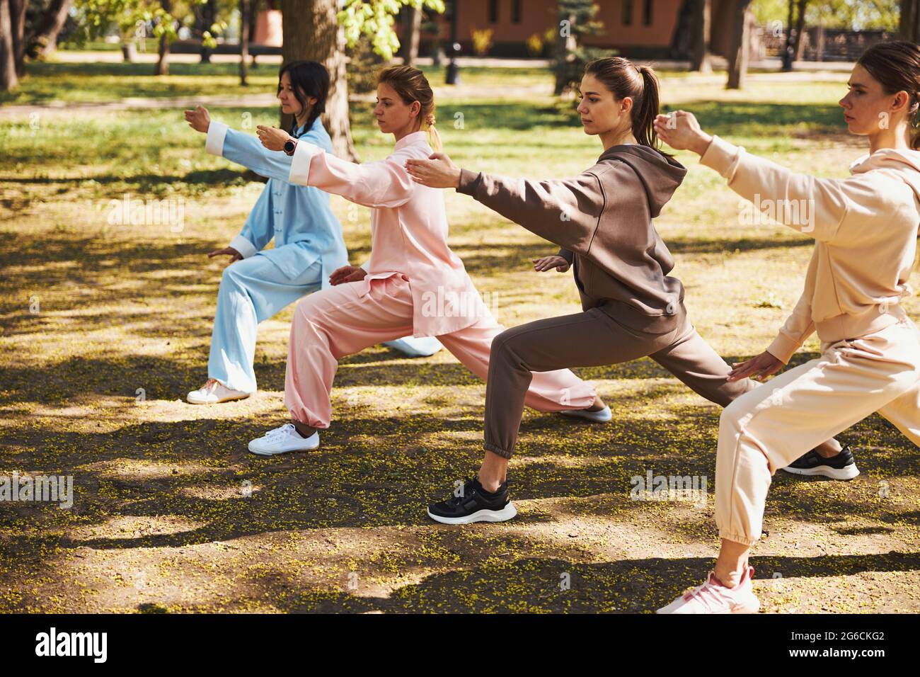 Attractive women working out outside doing tai chi Stock Photo - Alamy