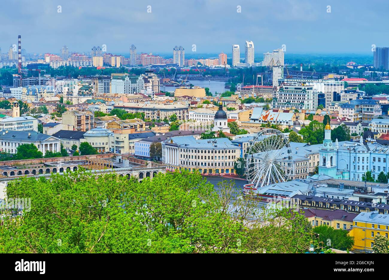 The view of historic buildings and ferris wheel in Podil neighborhood ...