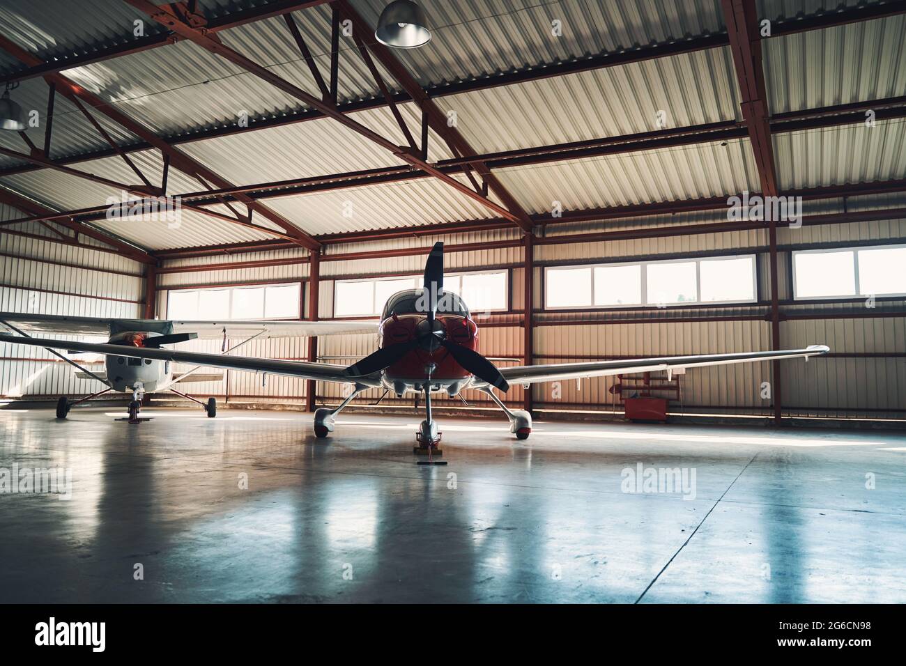 Airport parking building with two light aircrafts Stock Photo - Alamy