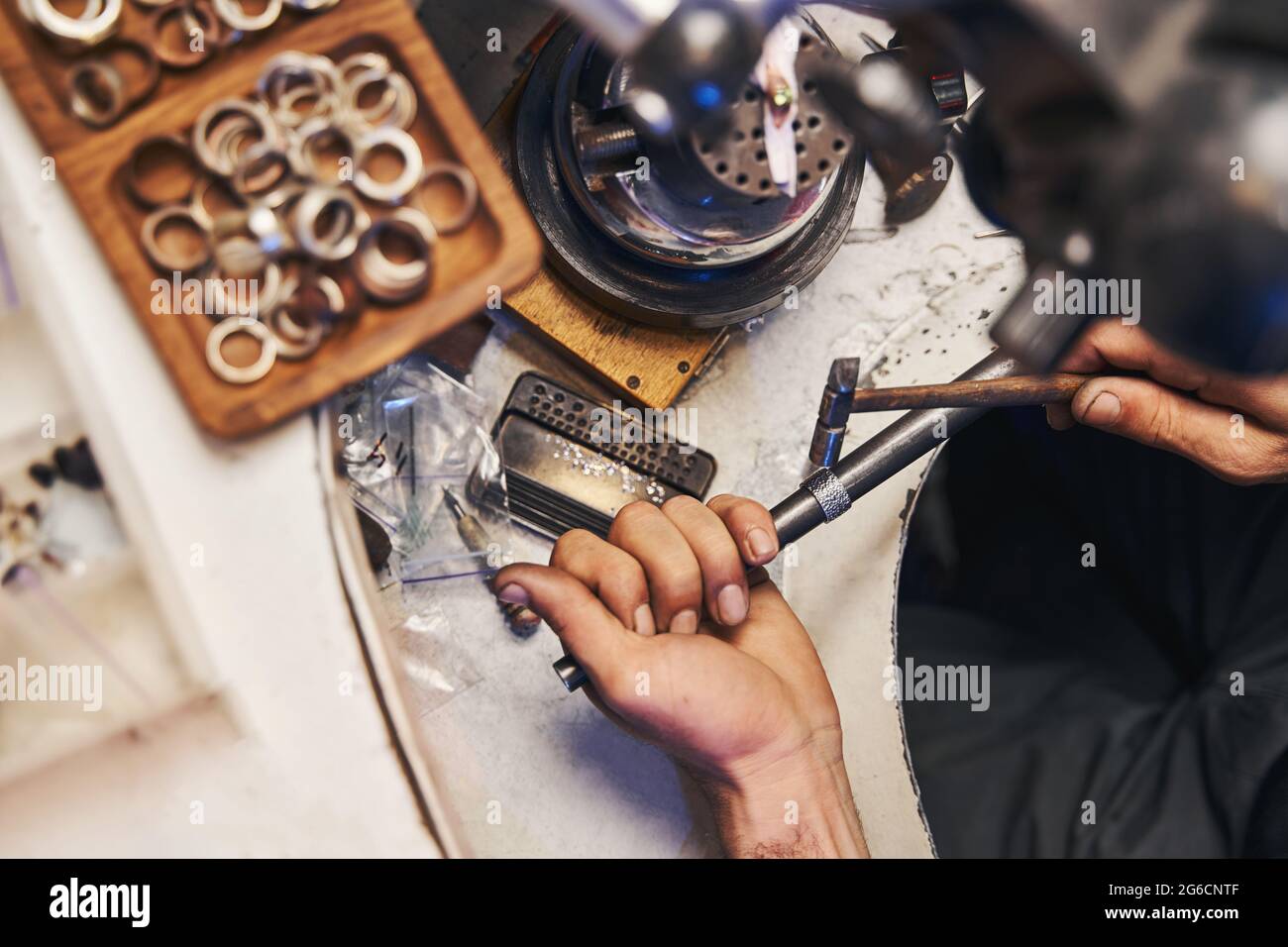 Jewelry maker using ball pein hammer for peening of ring Stock Photo Alamy