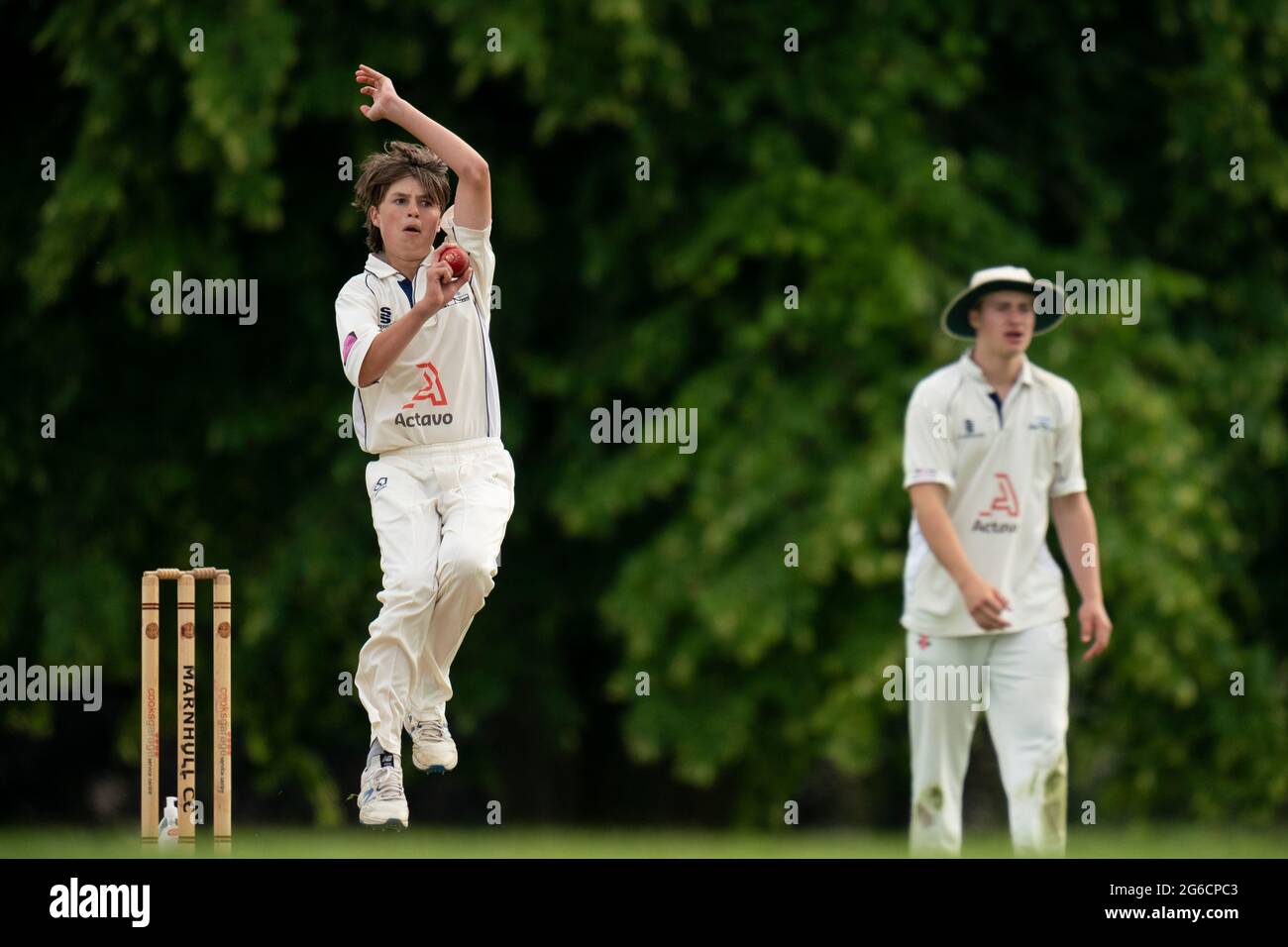 Young cricket bowler in action. Stock Photo