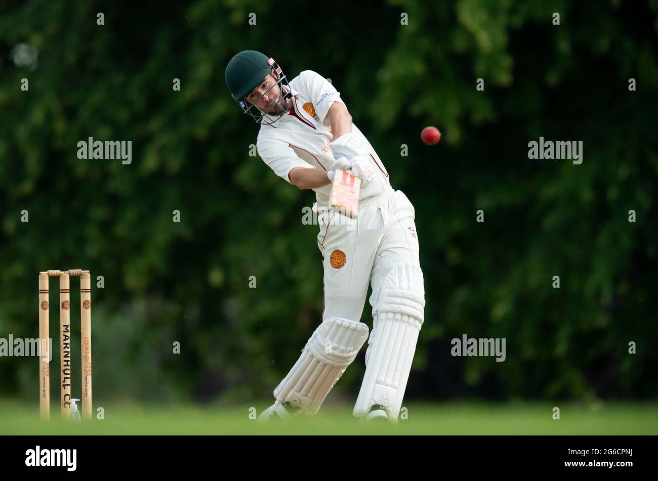 Cricket batsman hitting four runs. Stock Photo