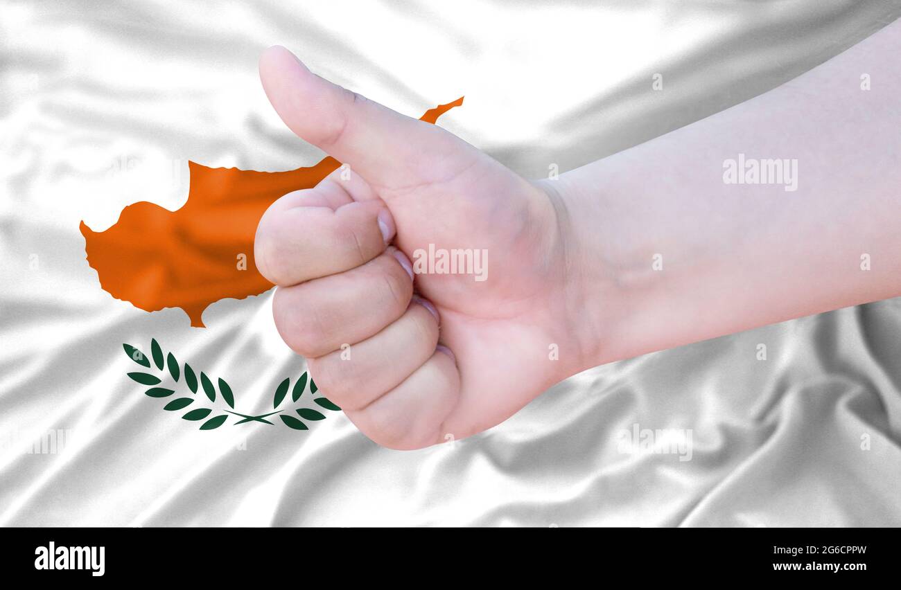 Hand makes a thumbs up sign on the background of the flag of Cyprus ...