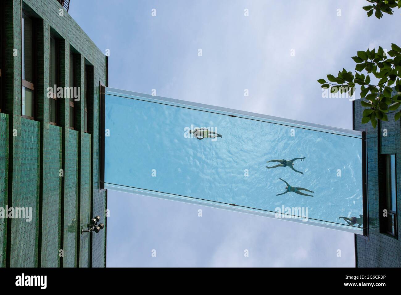 The 35-metre-high transparent Sky Pool bridge between two buildings at the Embassy Gardens is London's most exclusive outdoor pool. London, UK. Stock Photo