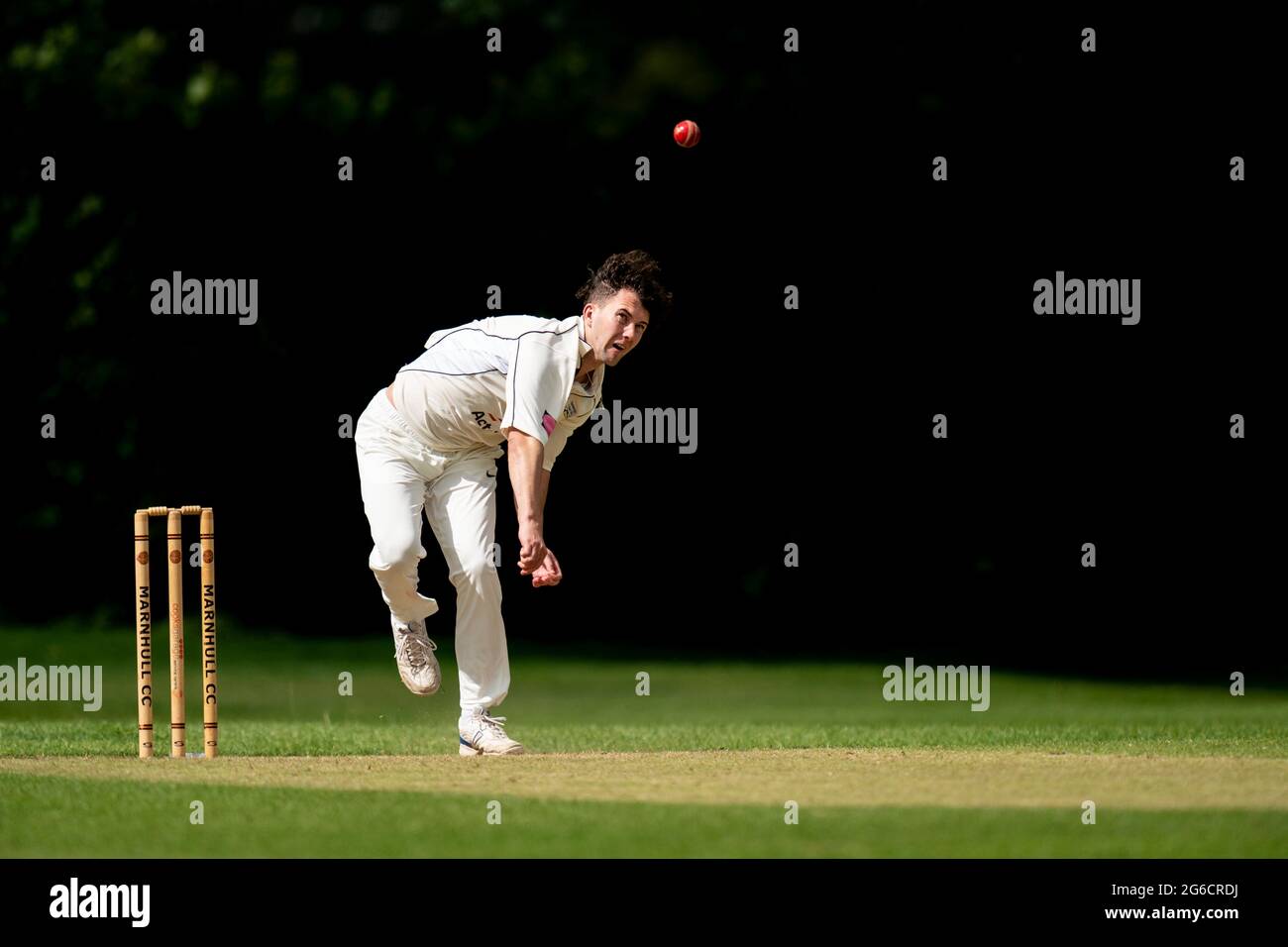 Cricket bowler in action. Stock Photo