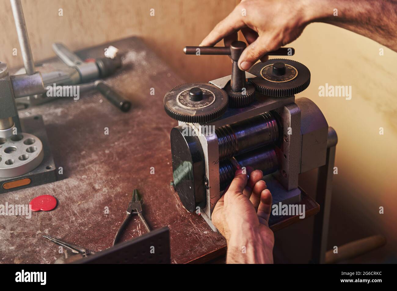 Jeweler turning top lever of rolling mill Stock Photo Alamy
