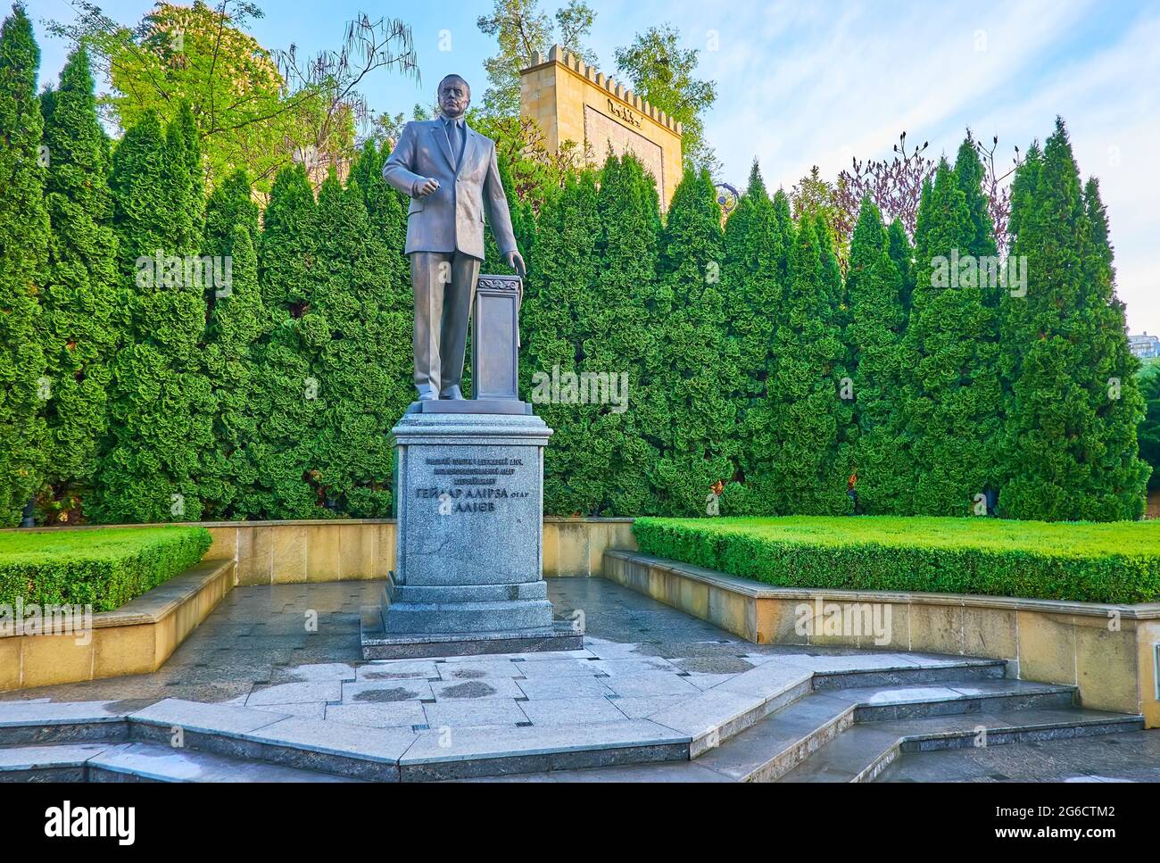 KYIV, UKRAINE - MAY 18, 2021: The monument to Heydar Aliyev in park with lush thuja trees in background, on May 18 in Kyiv Stock Photo