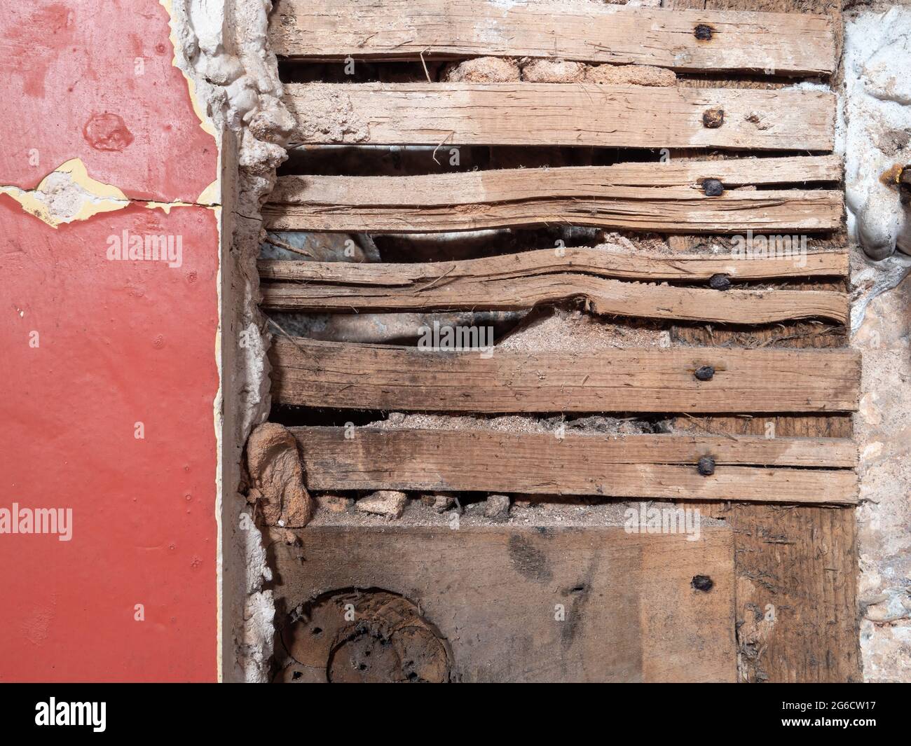 Detail of old lath and plaster wall in abandoned derelict building. Stock Photo