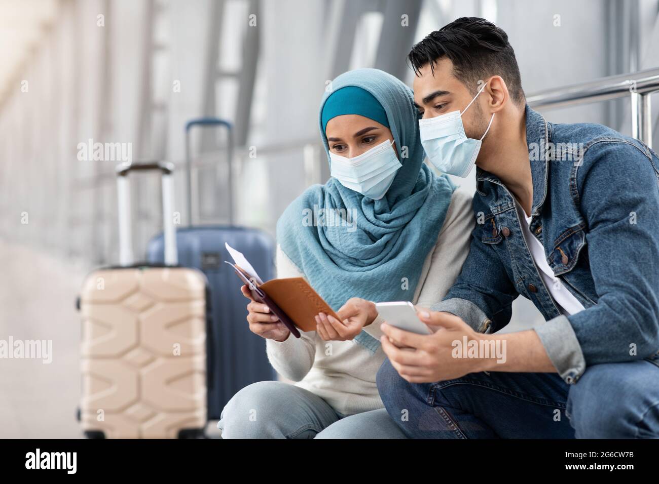 Muslim Couple In Medical Masks Waiting For Flight In Airport Terminal ...