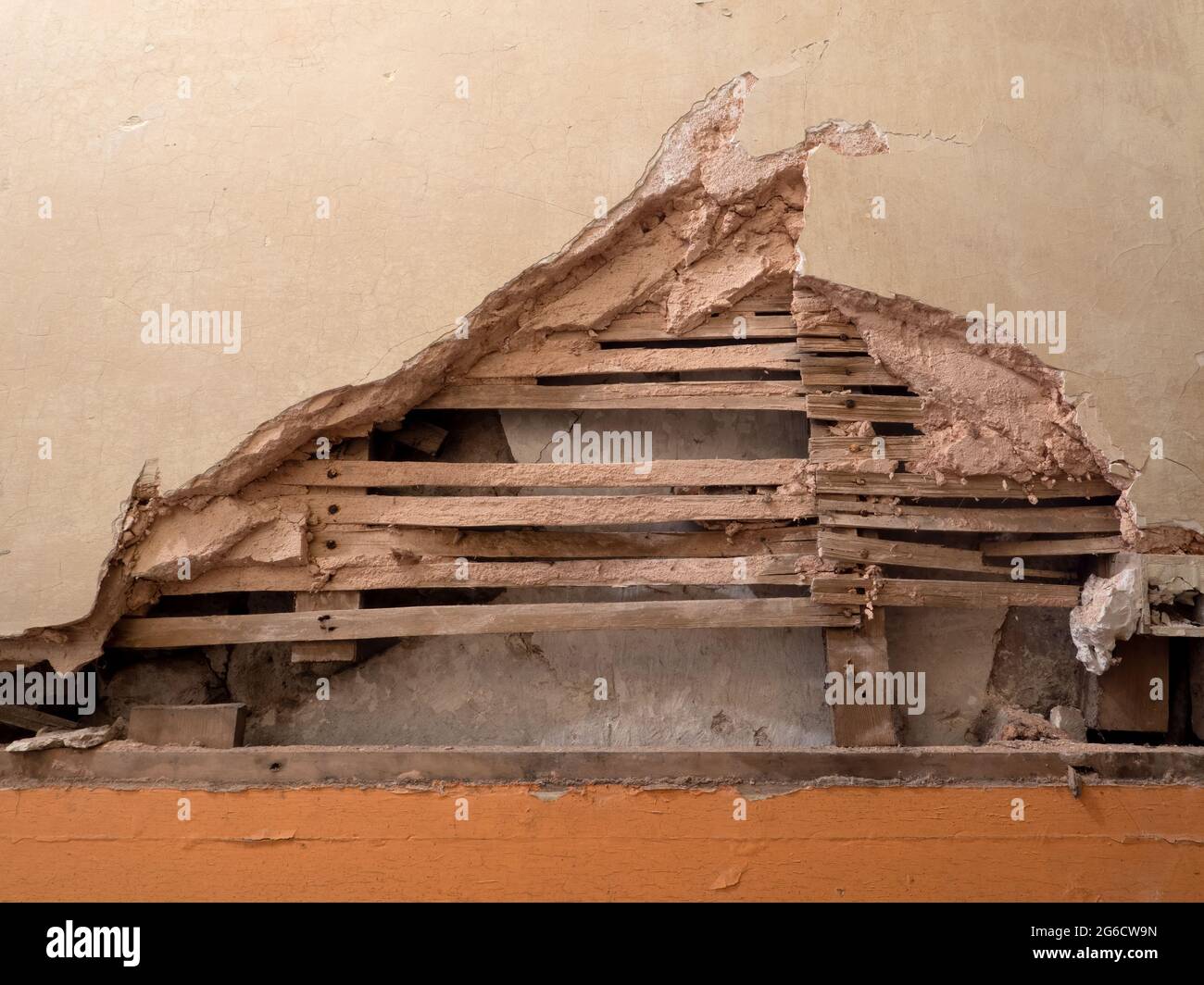 Detail of old lath and plaster wall in abandoned derelict building. Stock Photo