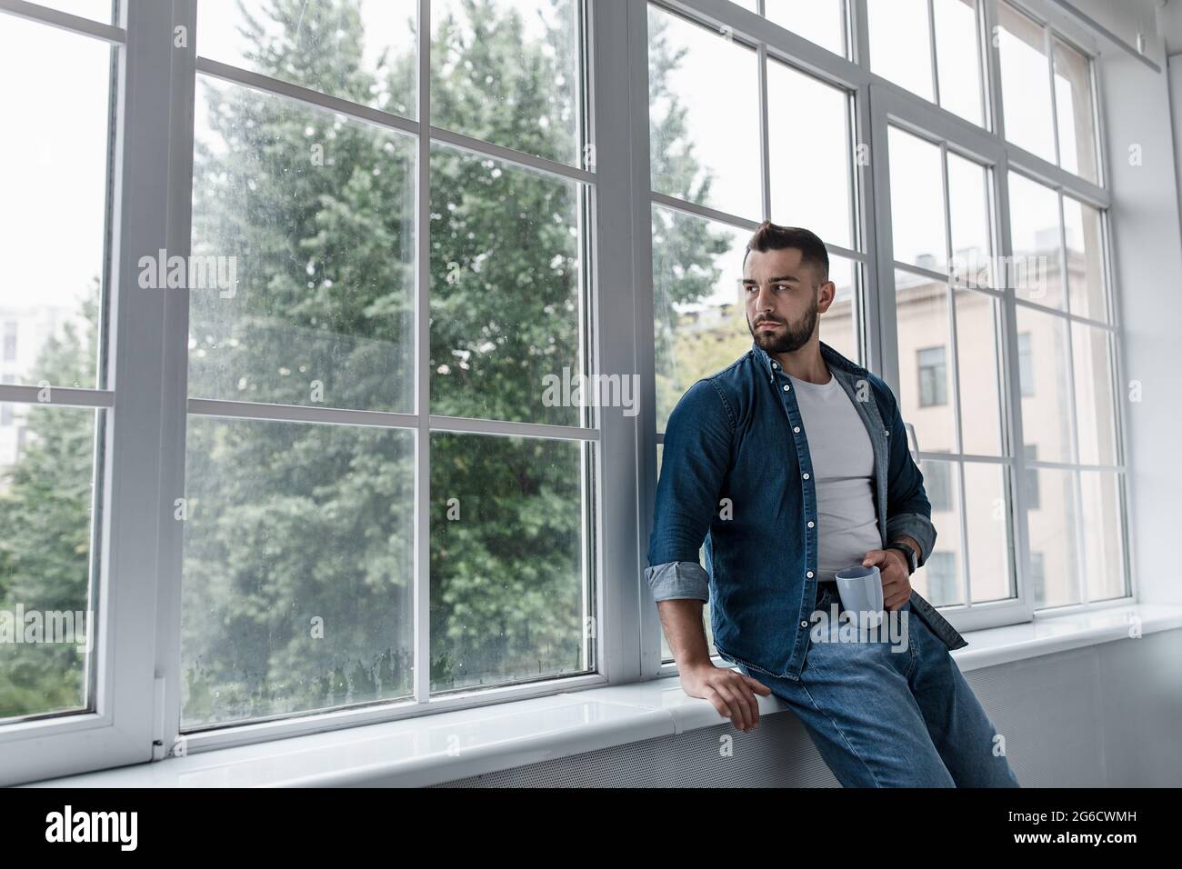 Tired male feeling sad tired and experiencing depression in mental health, problems and broken heart Stock Photo