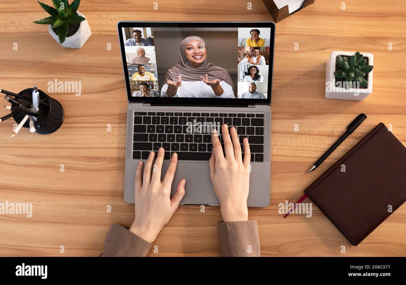 Lady Having Group Videoconference On Laptop While Working At Desk In Office Stock Photo