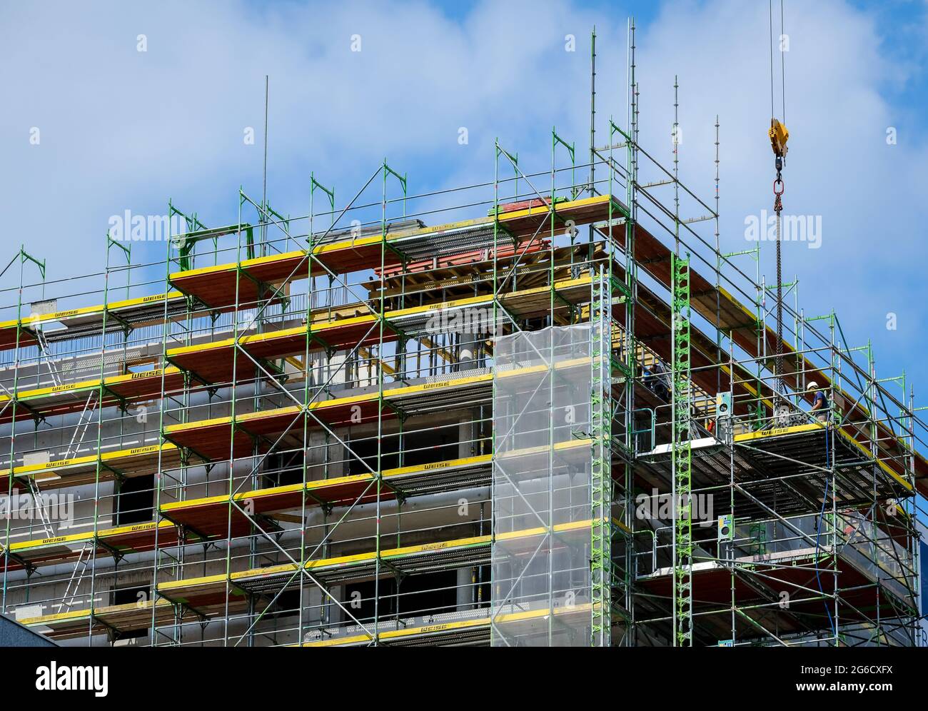 Essen, North Rhine-Westphalia, Germany - Scaffoldings, Construction site, New high-rise building with condominiums. Stock Photo