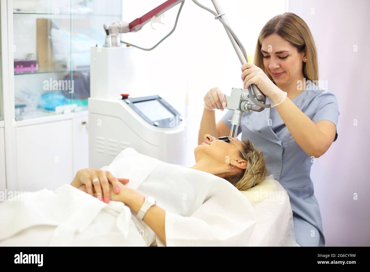 Beauty laser technician performing a cosmetic skin resurfacing session on a  female patient, also called a laser peel or photofacial Stock Photo - Alamy