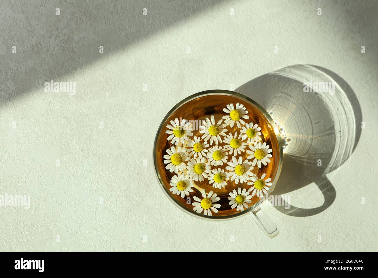 Cup of chamomile tea on white textured table Stock Photo - Alamy