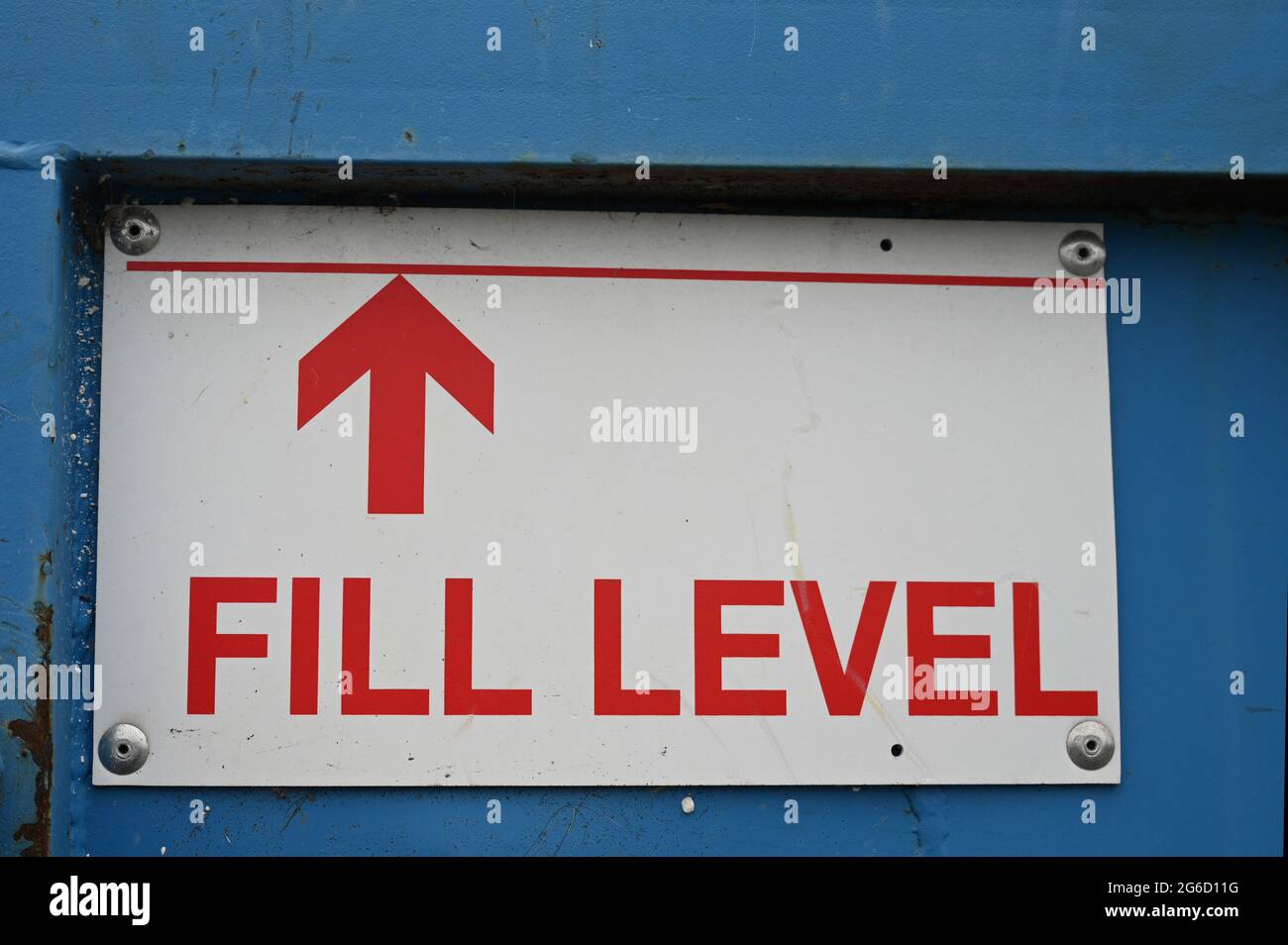 Fill level sign with arrow pointing upwards on blue refuse skip. Red ...