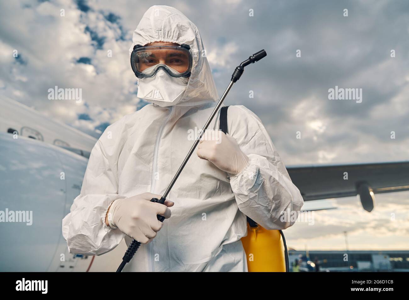 Airport worker dressed in protective gear looking ahead Stock Photo