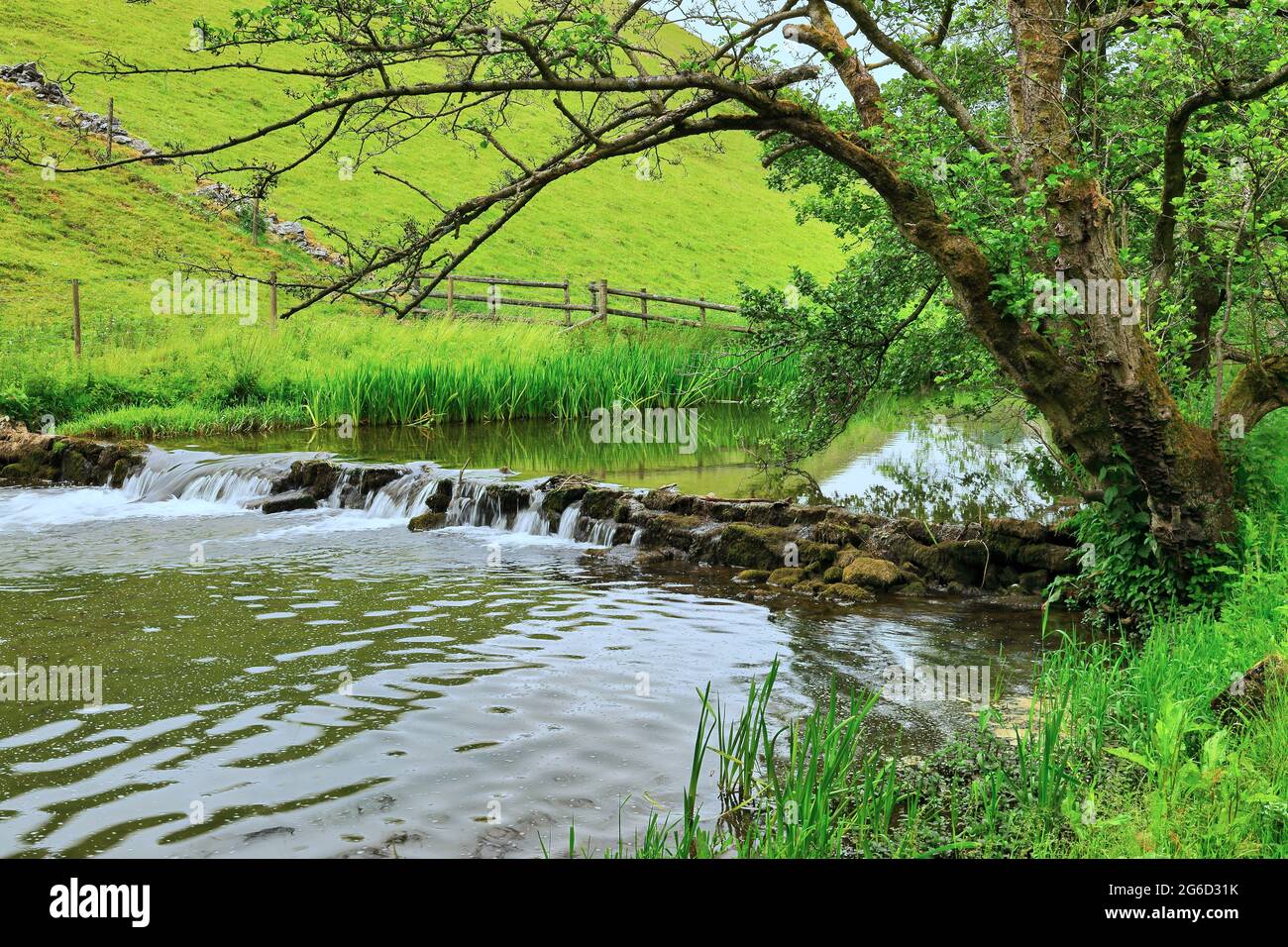 Waterfall on the River Dove in Wolfscote Dale in the Peak District near Hartington, Derbyshire, England, UK Stock Photo