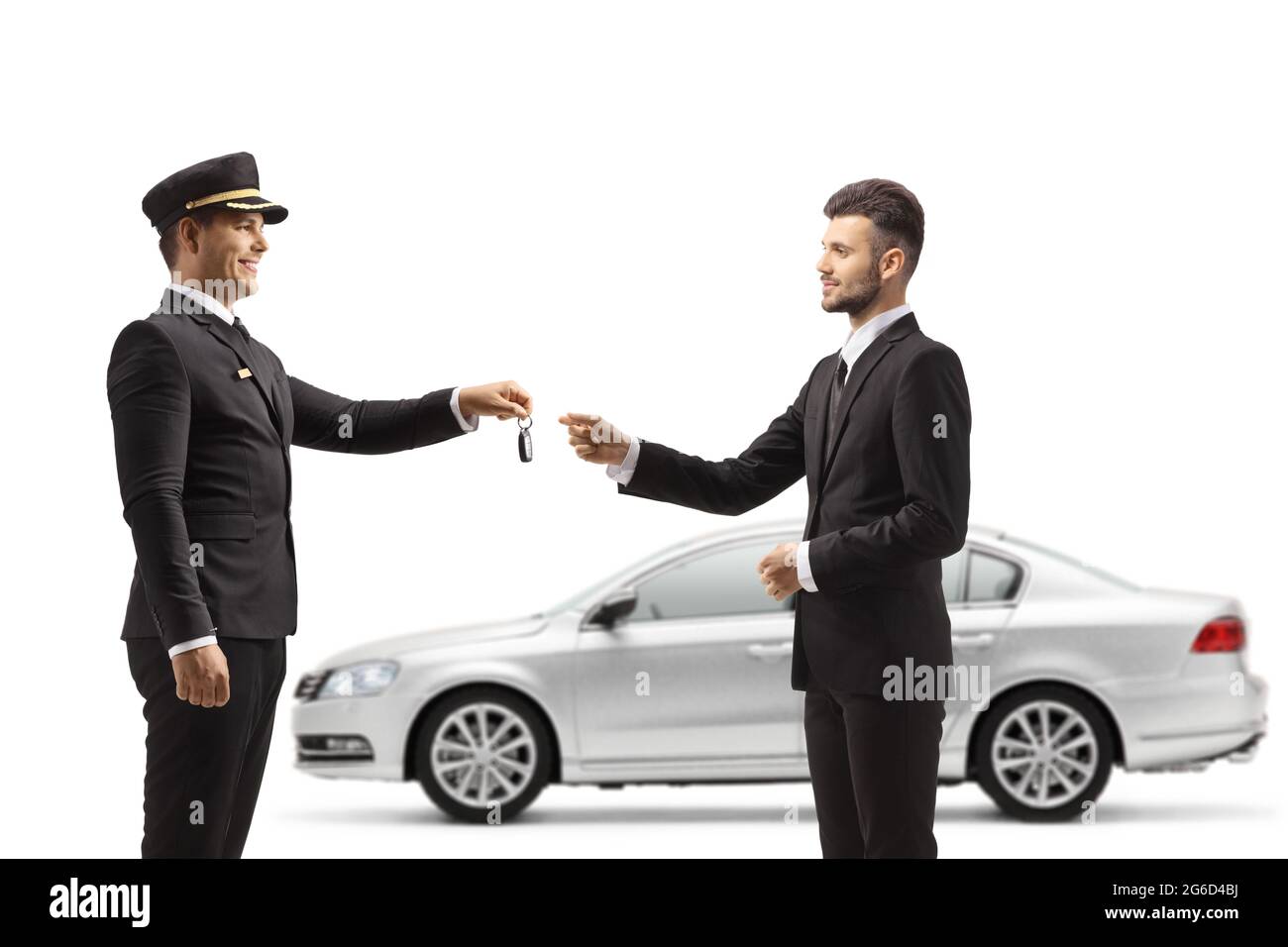 Chauffeur giving car keys from a silver car to a young businessman isolated on white background Stock Photo