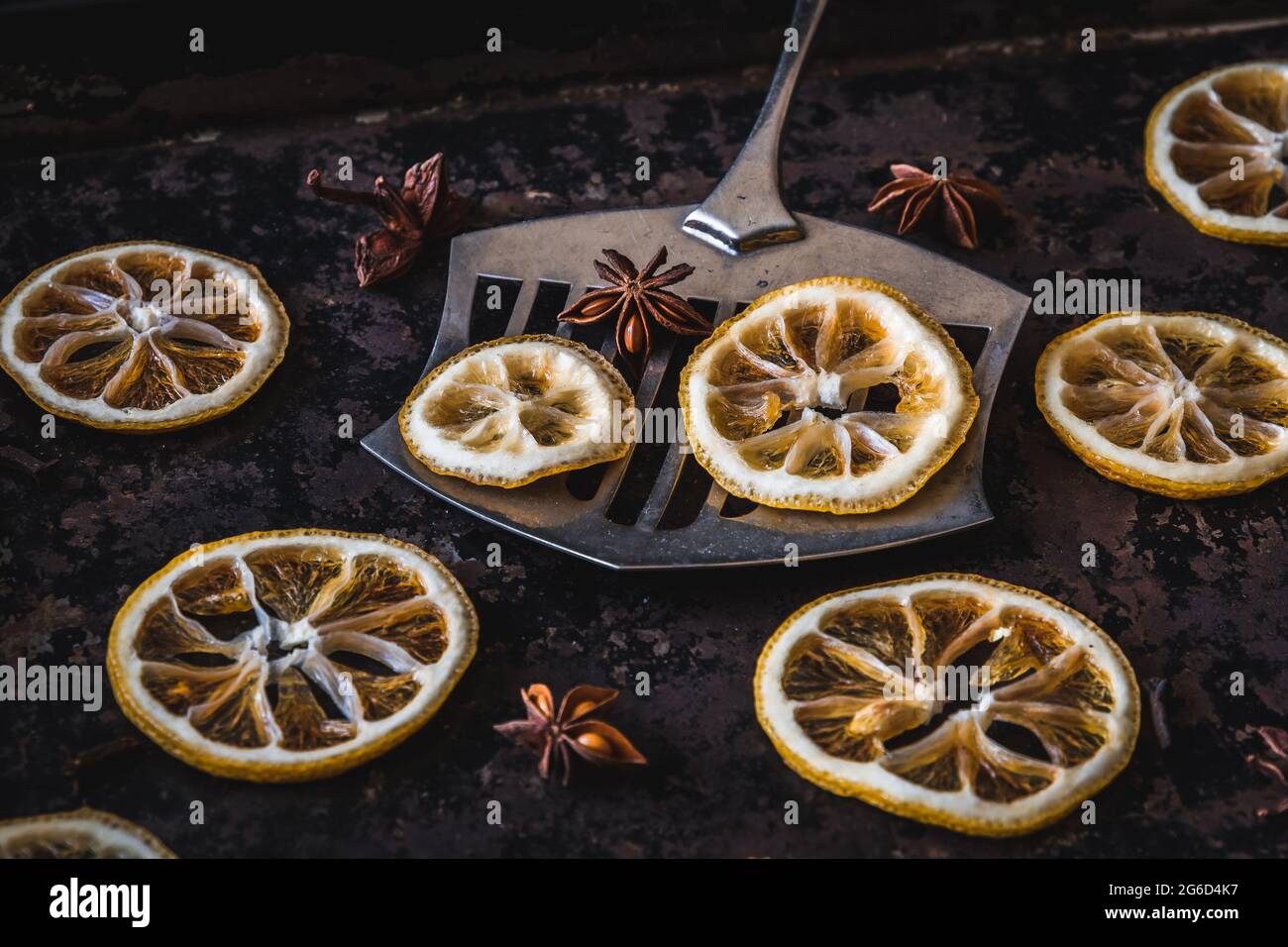 Dried lemons and oranges slices on an old baking sheet. Used for christmas decoration. Stock Photo