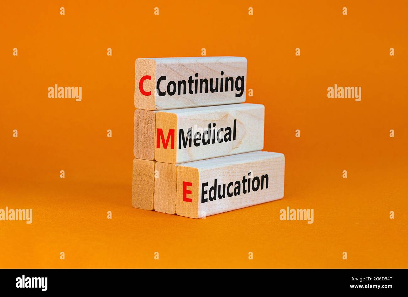 CME, continuing medical education symbol. Wooden blocks with words CME, continuing medical education on beautiful orange background. Business, CME, co Stock Photo