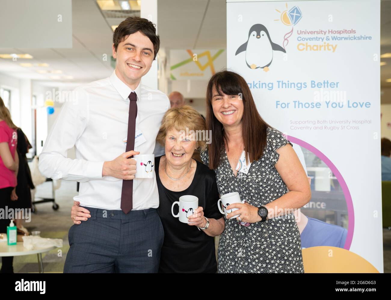 Margaret Keenan enjoys a NHS Big Thank You tea at UHCW, Coventry, where she received the worlds first non-clinical trail dose of Covid-19 vaccine. Pictured with grandson Liam Maton and daughter Sue Maton. Stock Photo