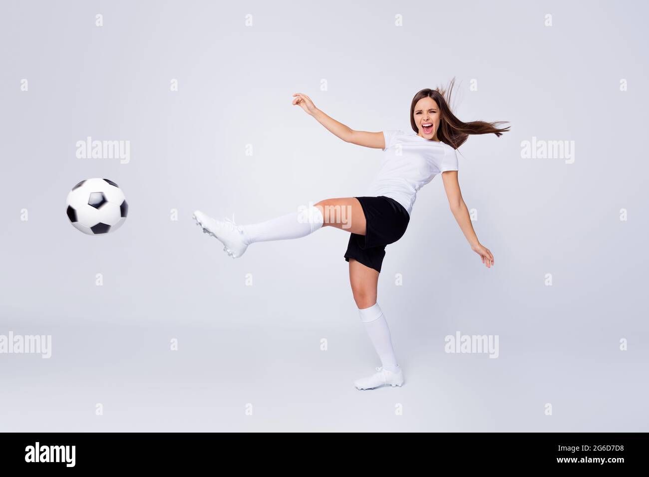 Full length photo of excited captain lady player soccer women team kicking  leg leather ball wear football uniform t-shirt shorts boots knee socks  Stock Photo - Alamy