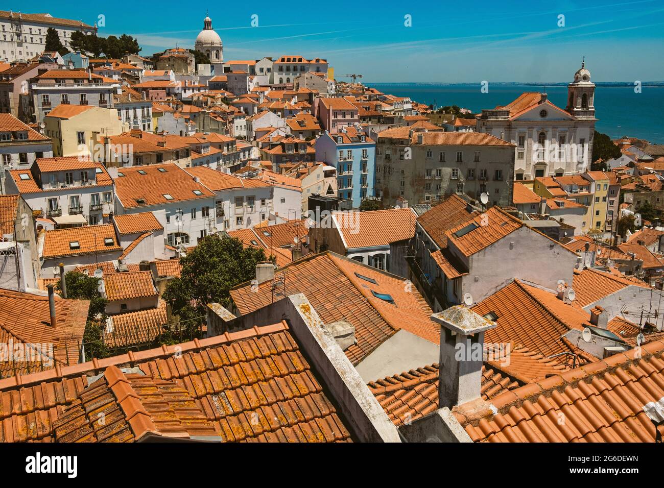 Lisbon skyline rooftop view on a sunny summer day with traditonal orange rooftops of the Alfama