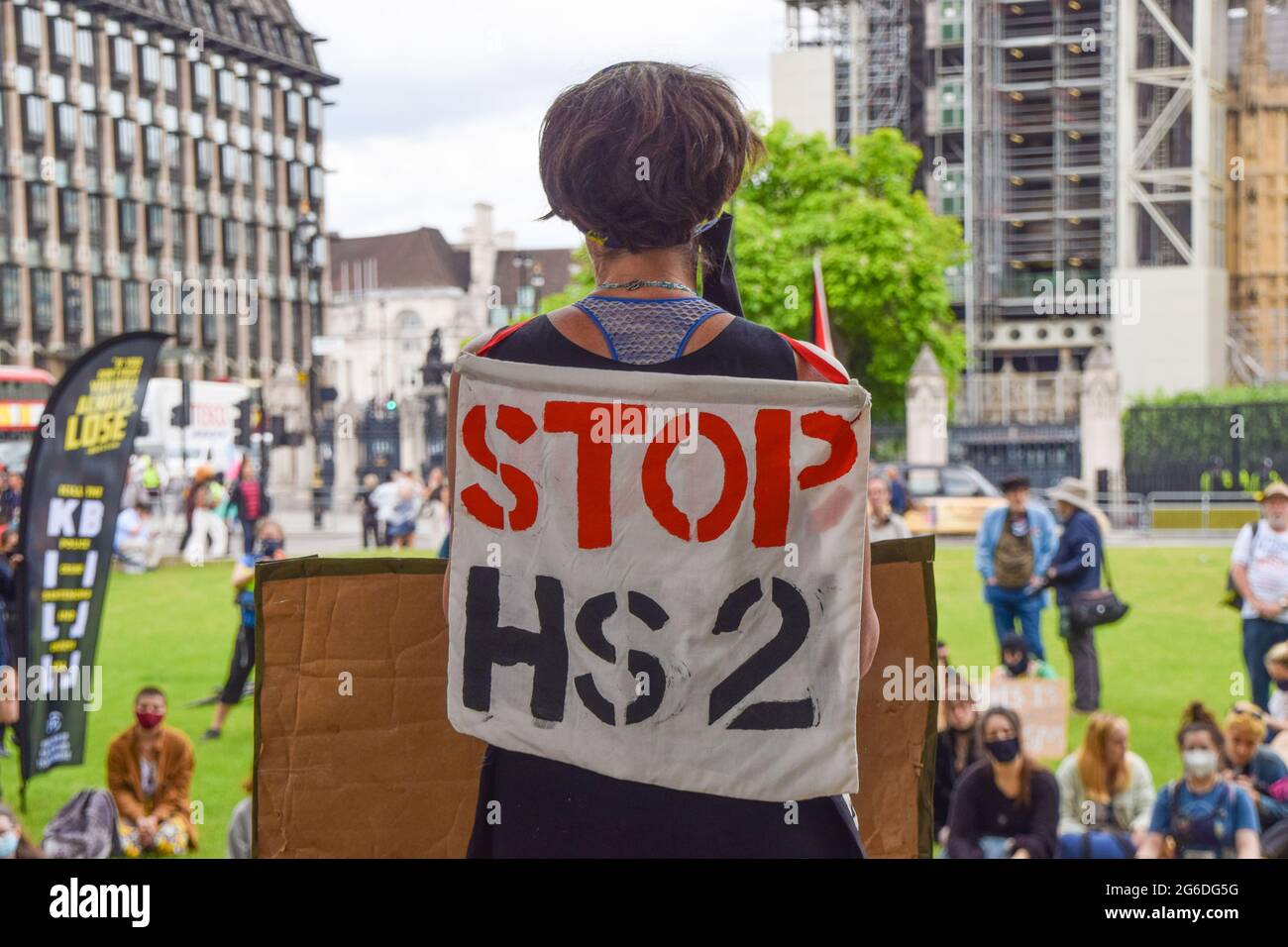London, United Kingdom. 5th July 2021. A protester carries a 'Stop HS2' banner at the Kill The Bill protest. Demonstrators gathered in Parliament Square in protest against the Police, Crime, Sentencing and Courts Bill, which many say would give police more powers over protests in the UK. (Credit: Vuk Valcic / Alamy Live News) Stock Photo