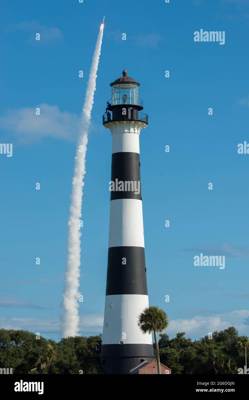 United Launch Alliance's Delta IV GPS III Magellan rocket launches in the background of the Cape Canaveral Lighthouse on August 22, 2019, at Cape Canaveral Air Force Station. The GPS-III launched from Space Launch Complex-37 and represents the next step in modernizing the navigation network worldwide with a new generation of satellites to offer improved accuracy, better resiliency and a new signal for civil users. (U.S. Air Force photo by James Rainier) Stock Photo