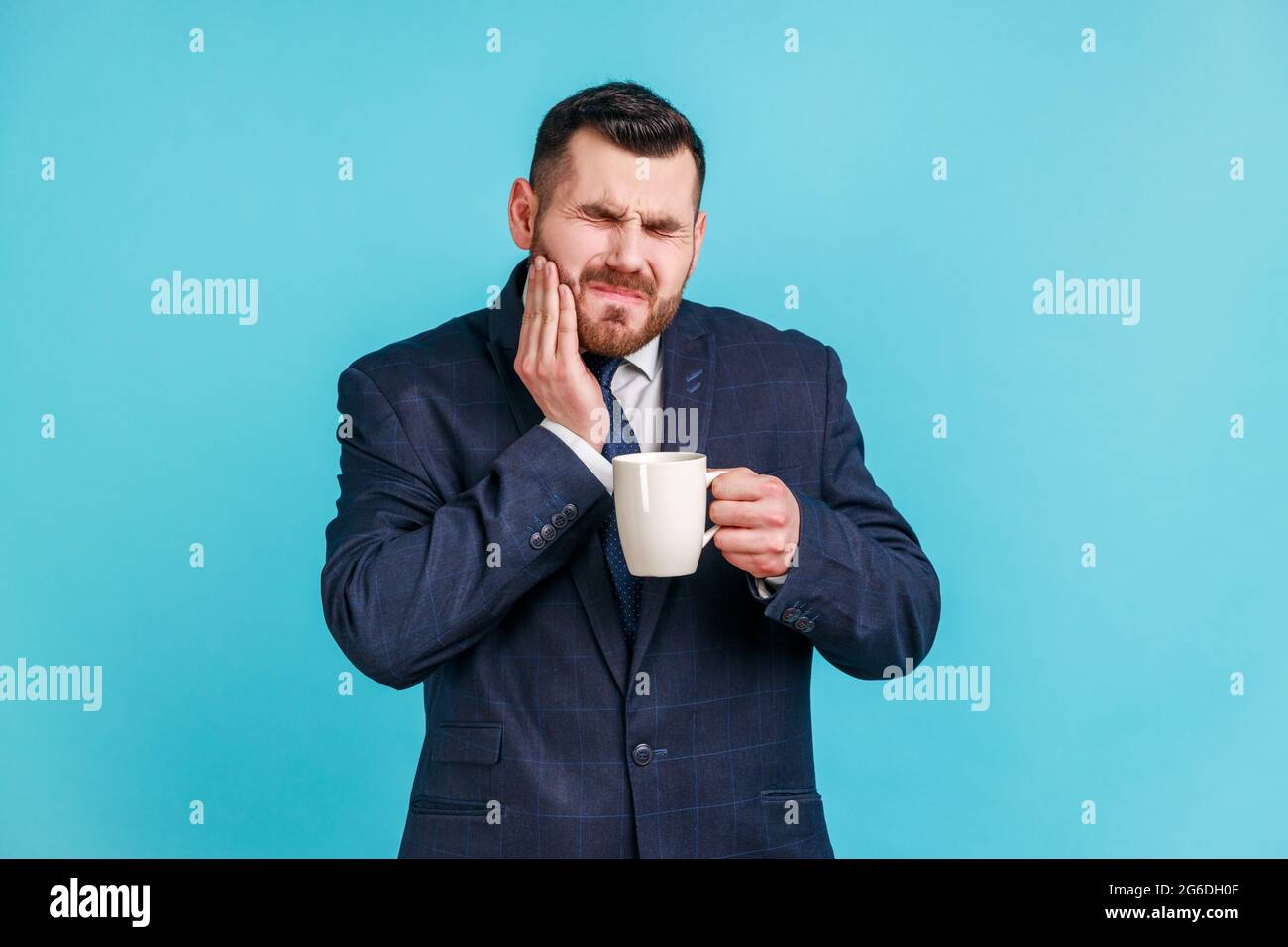 Toothache. Portrait of upset bearded man in elegant suit suffering from
