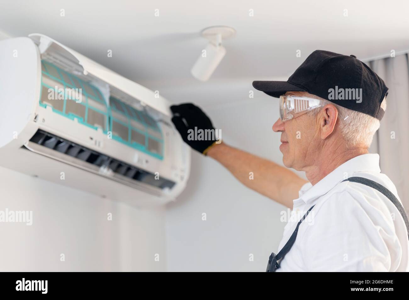 Worker man instal ac conditioner from home or office, maintenance of