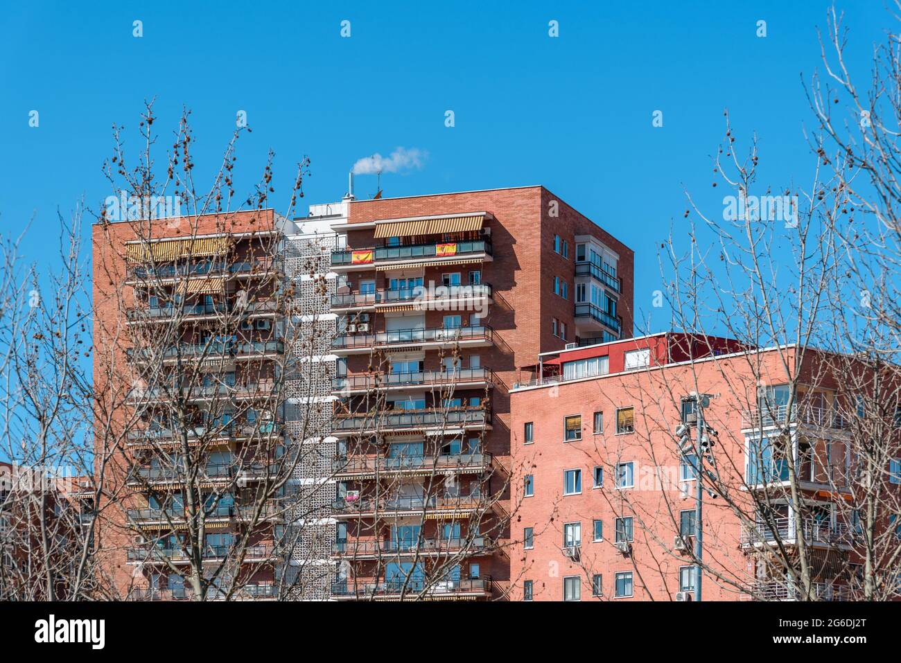 Apartment Building against blue sky. Madrid, Latina District. Real estate and residential market concepts Stock Photo