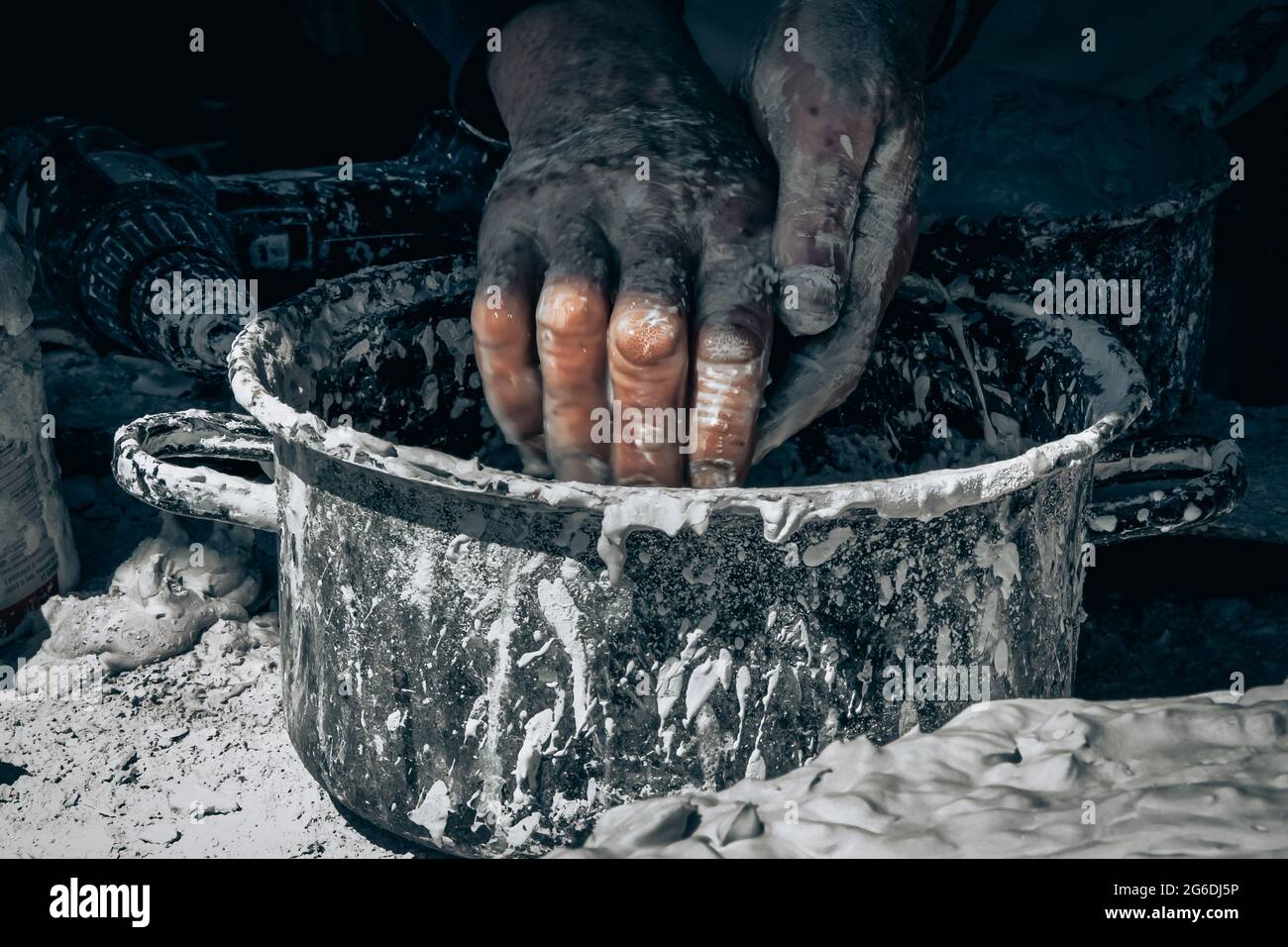 Man washing his hands after working with clay Stock Photo