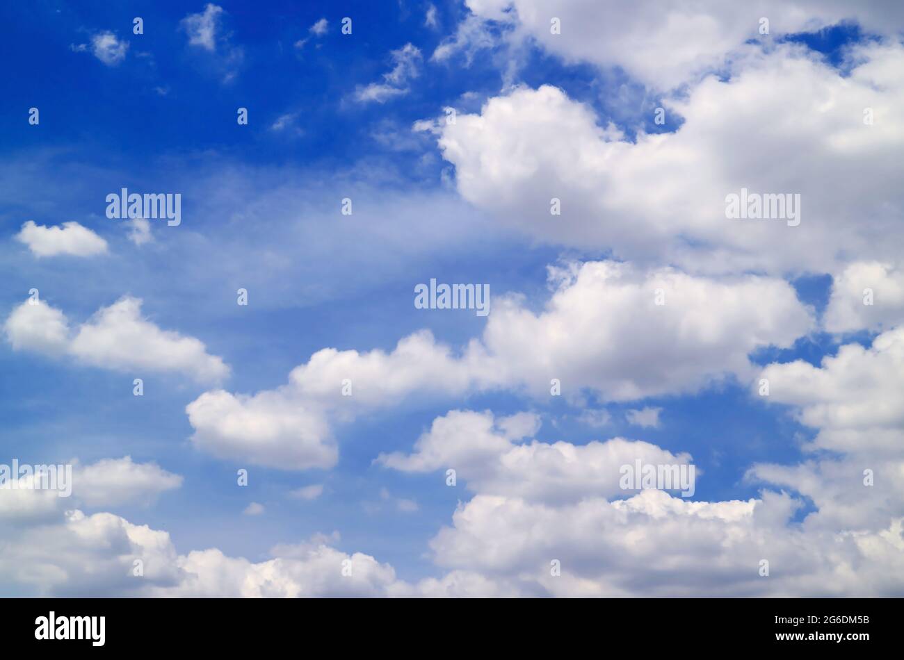 White Clouds Spread on the Vivid Blue Sky Stock Photo - Alamy