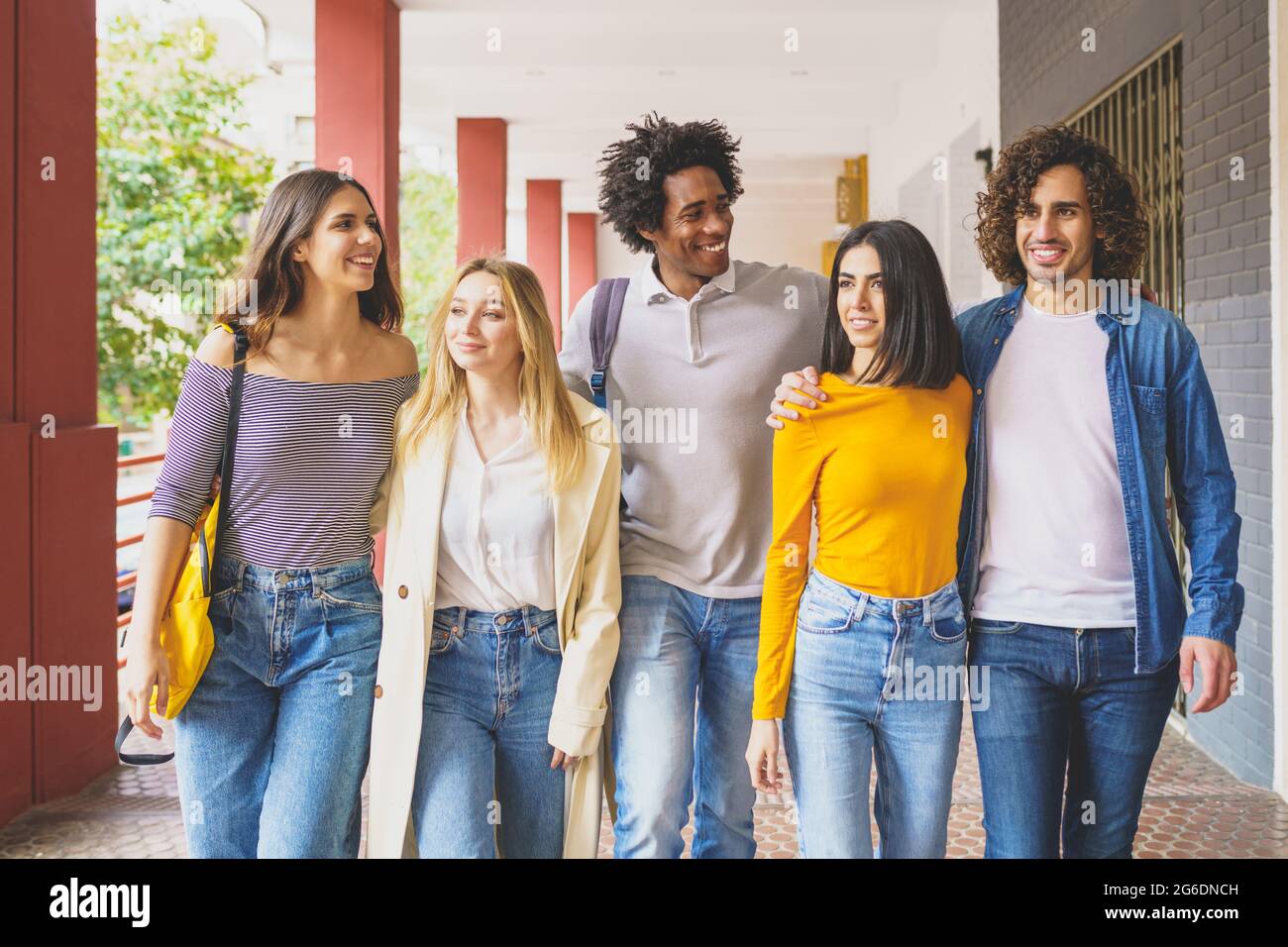 Multi-ethnic group of students walking together on the street. Stock Photo