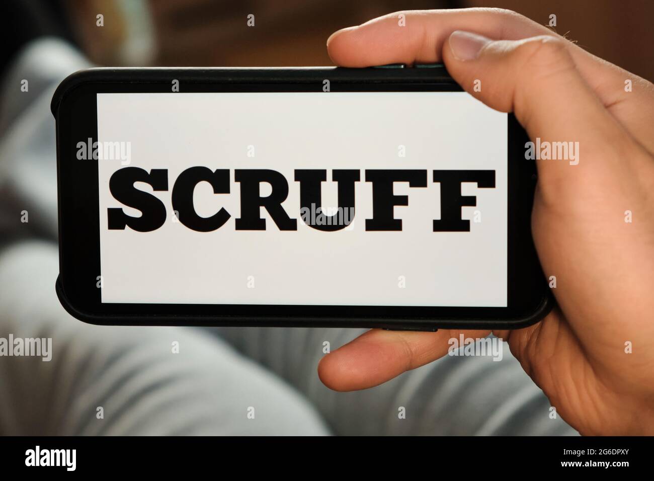 Scruff logo on the smartphone display. Man uses an application for dating and looking for the partner, June 2021, San Francisco, USA Stock Photo