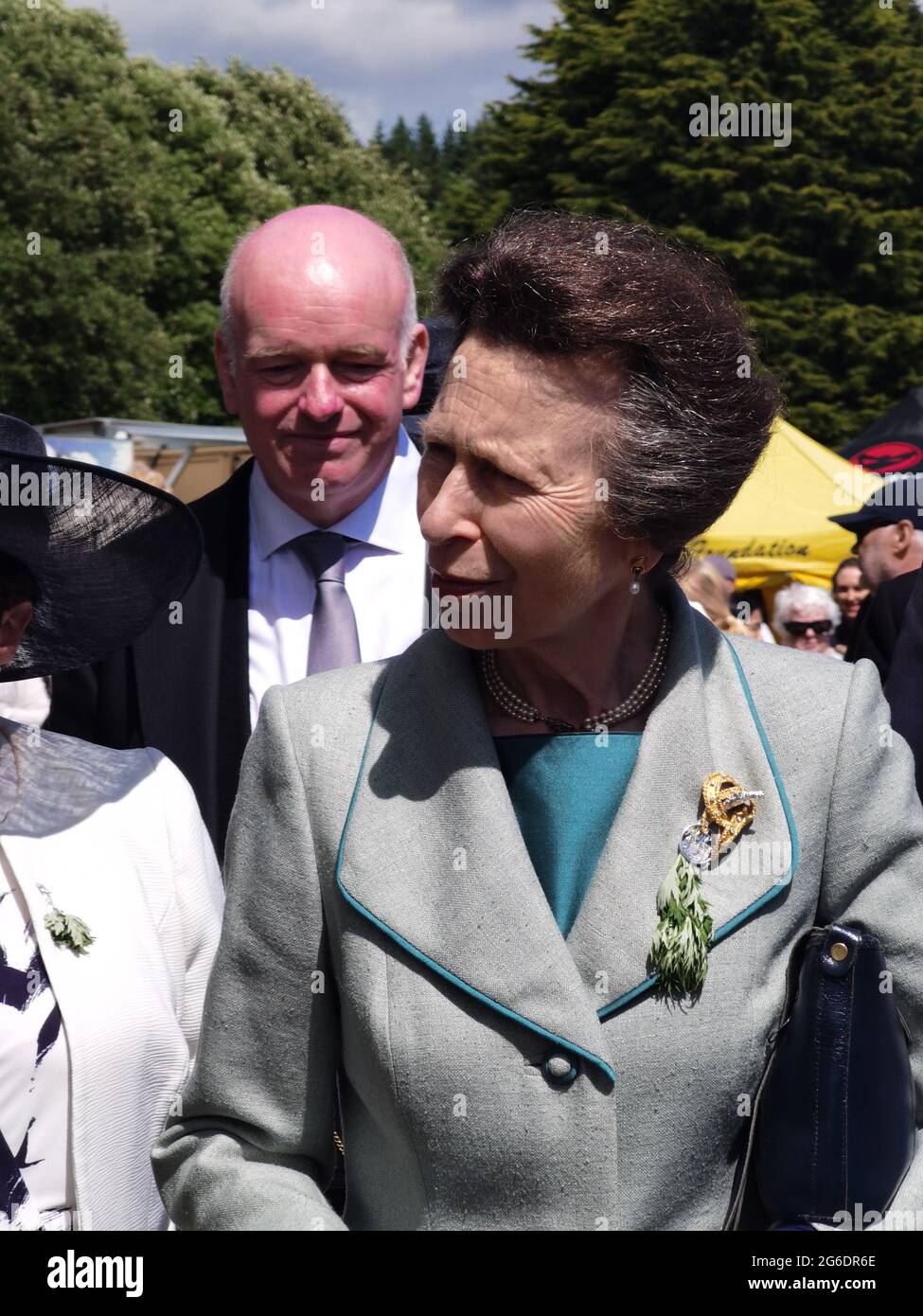5 July 2021, St Johns, Isle of Man. No social distancing or masks. Her Royal Highness, Princess Anne, Princess Royal of the United Kingdom accompanied by Howard Quayle, Chief Minister of the Isle of Man, greeting people at a Tynwald Fair on an official visit to the Isle of Man where she presided over the open air sitting of Tynwald (the Parliament of the Isle of Man. She is shown visiting a local farm shop at the Tynwald fair. The Isle of Man opened borders to non-residents on 28 June 2021 and has very few social distancing requirements (https://covid19.gov.im/). Stock Photo