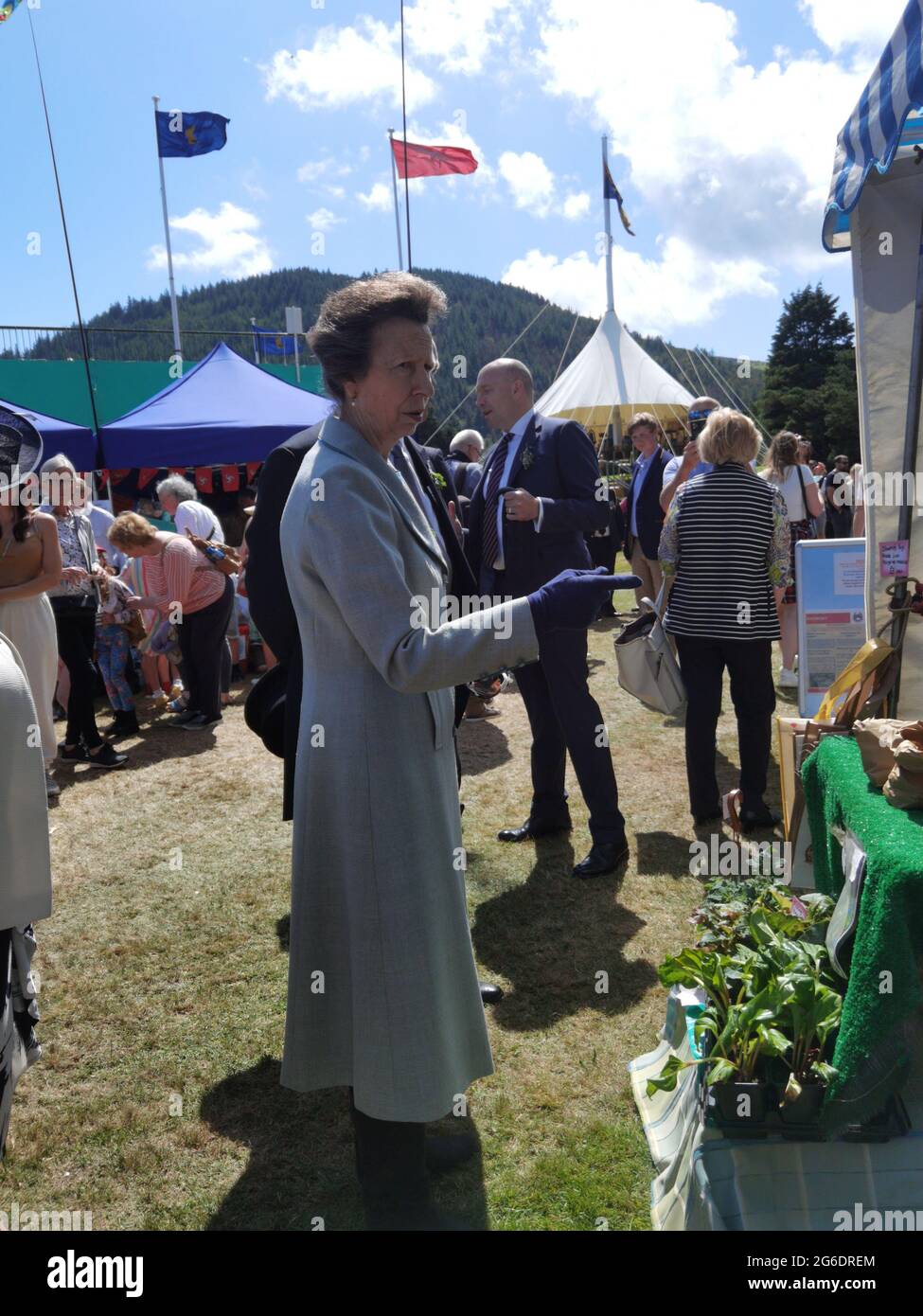 5 July 2021, St Johns, Isle of Man. No social distancing or masks. Her Royal Highness, Princess Anne, Princess Royal of the United Kingdom greeting people at a fair on an official visit to the Isle of Man where she presided over the open air sitting of Tynwald (the Parliament of the Isle of Man). The Princess seemed to enjoy her visit and was very generous with her time. She is shown here visiting a local farm shop at the Tynwald fair. The Isle of Man opened borders to non-residents on 28 June 2021 and has very few social distancing requirements (https://covid19.gov.im/). Stock Photo