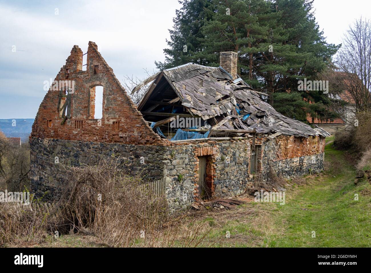 Damaged old house in the village Stock Photo