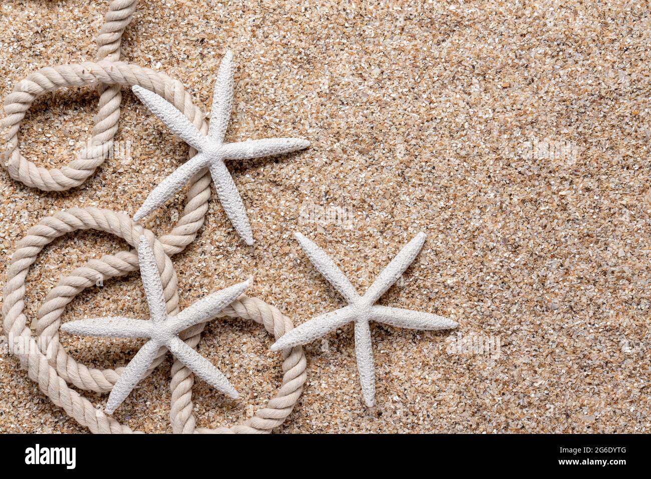 nautical rope and white starfish border in the sand Stock Photo - Alamy