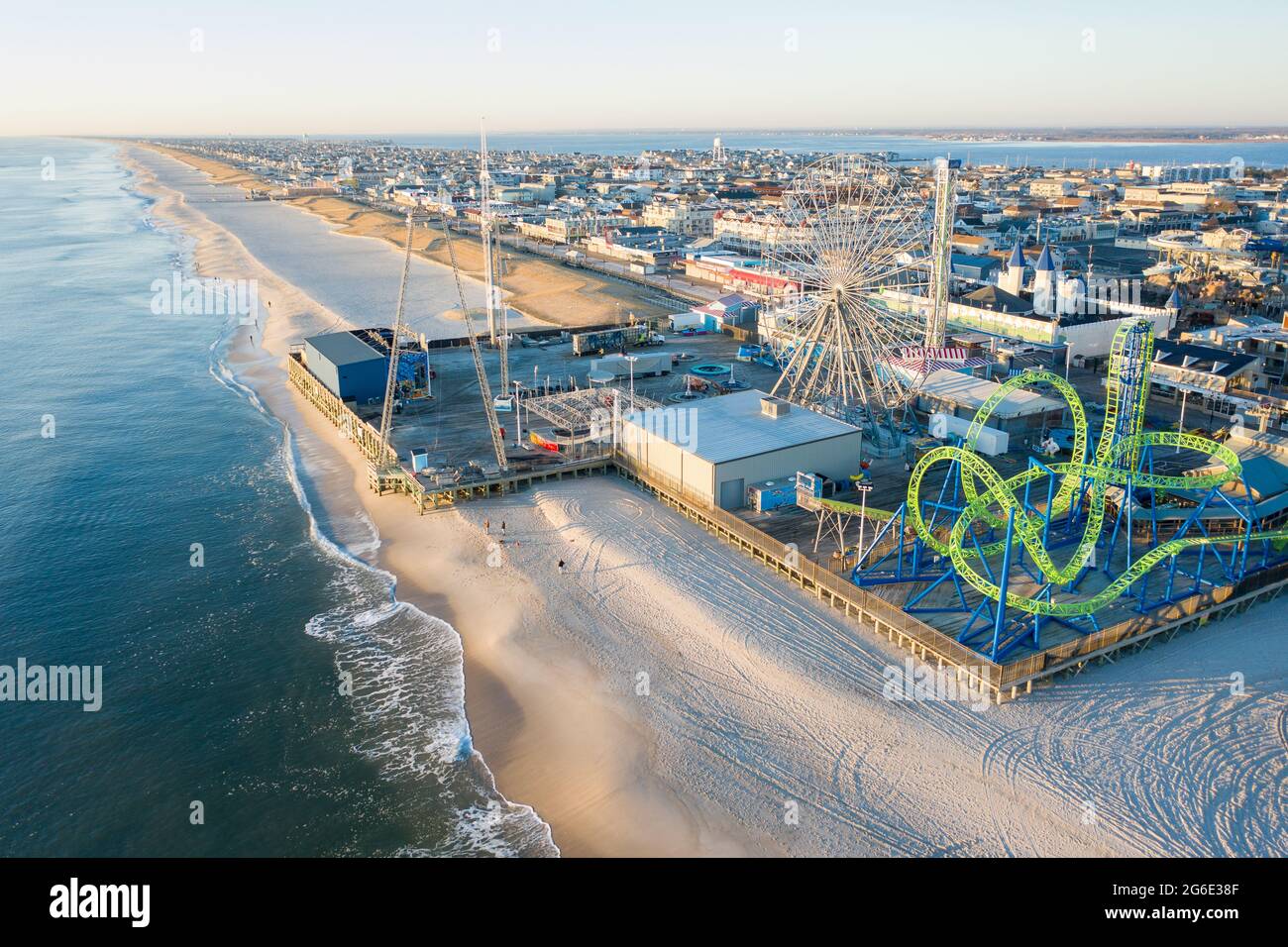 Aerial of New Jersey shoreline with amusement rides along the boardwalk and sand. Stock Photo