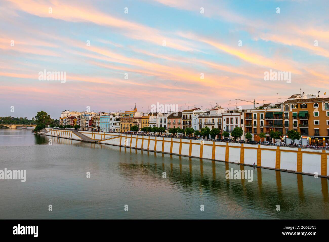 View over the river Rio Guadalquivir, waterfront at Calle Betis in Triana, sunset, Sevilla, Andalusia, Spain Stock Photo