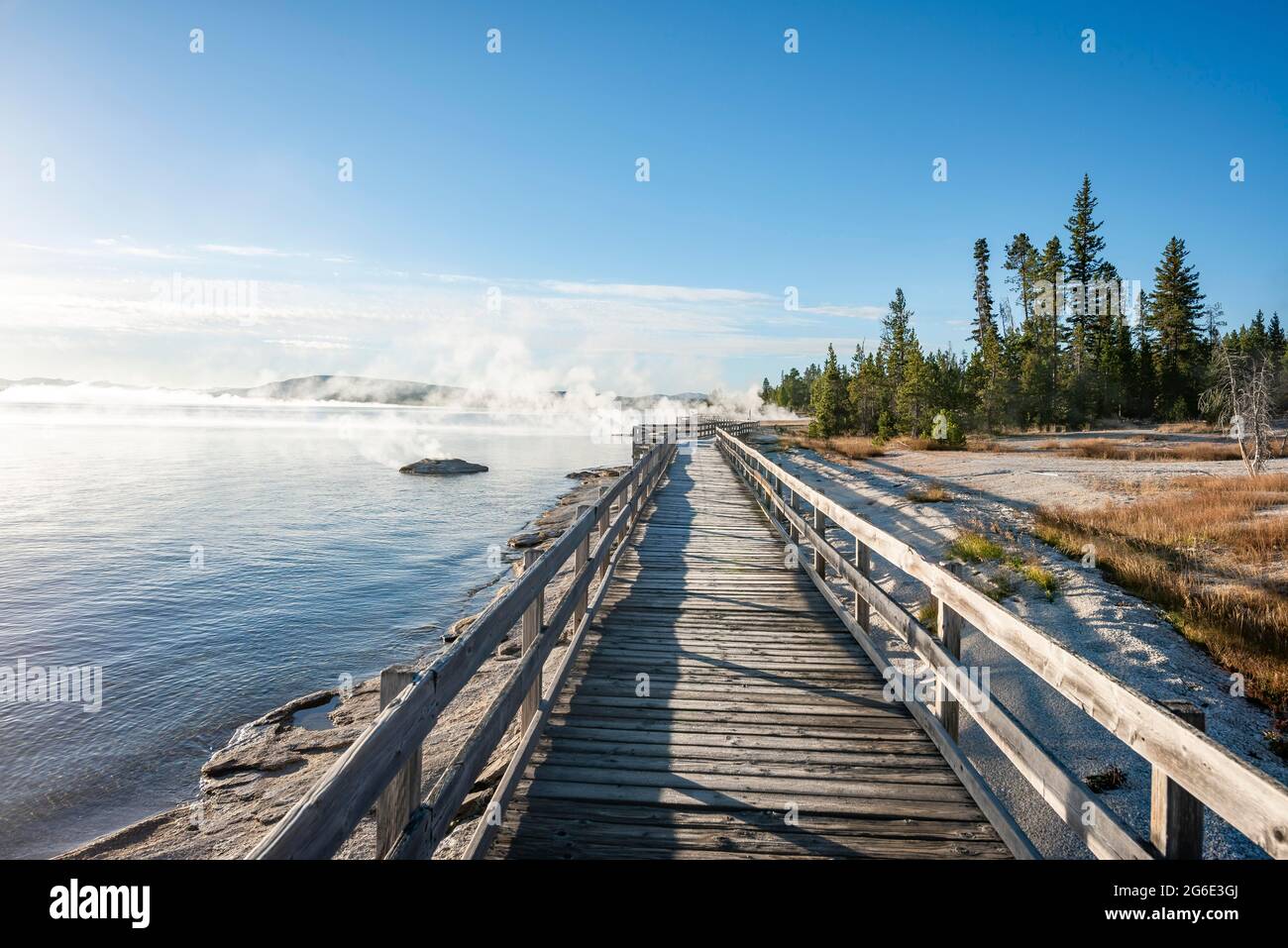 Boardwalk on the shore of the West Thumb of Yellowstone Lake, morning sun, West Thumb Geyser Basin, Yellowstone National Park, Wyoming, USA Stock Photo