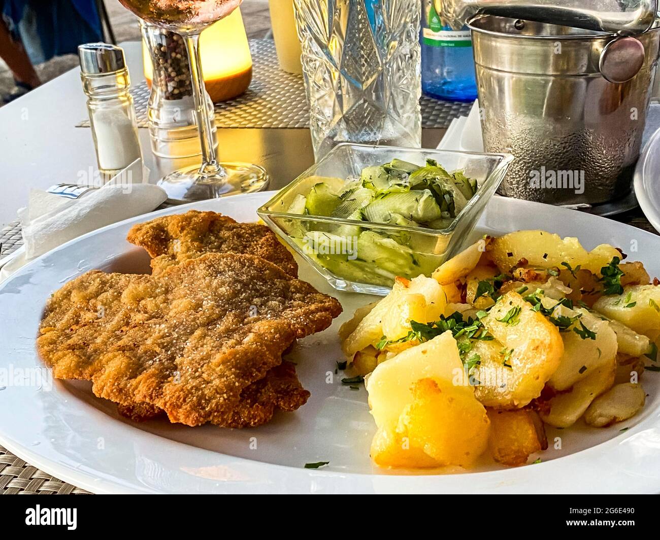 Original Viennese veal escalope with fried potatoes and cucumber salad, Port Andratx, Majorca, Spain Stock Photo